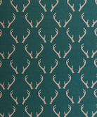 Green polo shirt with deer antler pattern and light gray shorts on a white background