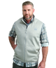 Man wearing a light gray vest WITH ZIPPER over a plaid shirt on a white background HUK GEAR