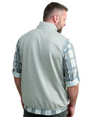 Man wearing a light gray vest WITH ZIPPER over a plaid shirt on a white background HUK GEAR