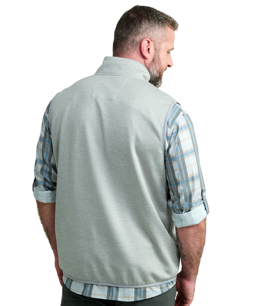 Man wearing a light gray vest WITH ZIPPER over a plaid shirt on a white background HUK GEAR