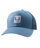 A blue trucker-style baseball cap with a structured front panel, curved brim, and dark mesh back panels. A square embroidered patch on the front displays a stylized 'H' logo above the word 'Huk', indicating the brand.