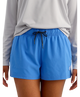 Person wearing blue shorts and a gray long-sleeve shirt on a white background