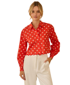 Woman wearing a red blouse with white HEART pattern on a white background