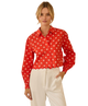 Woman wearing a red blouse with white HEART pattern on a white background