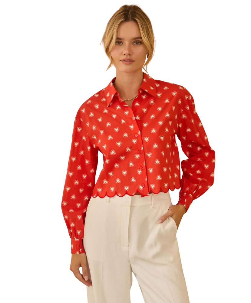 Woman wearing a red blouse with white HEART pattern on a white background