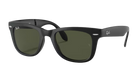 Black sunglasses with green lenses on a white background