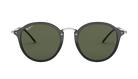 Round Ray-Ban sunglasses with black frames and green polarized lenses on a white background