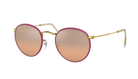 Round Ray-Ban sunglasses with pink gradient lenses and gold frames on a white background
