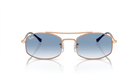 Sunglasses with blue gradient lenses and gold frame on a white background