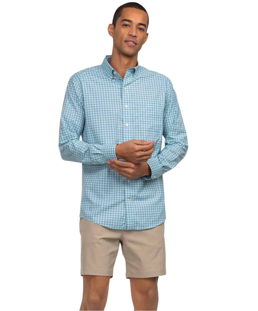 Man wearing a light blue checkered shirt and beige shorts on a white background