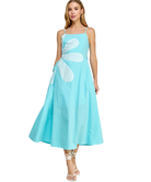 Woman wearing a light blue dress with white floral patterns on a white background