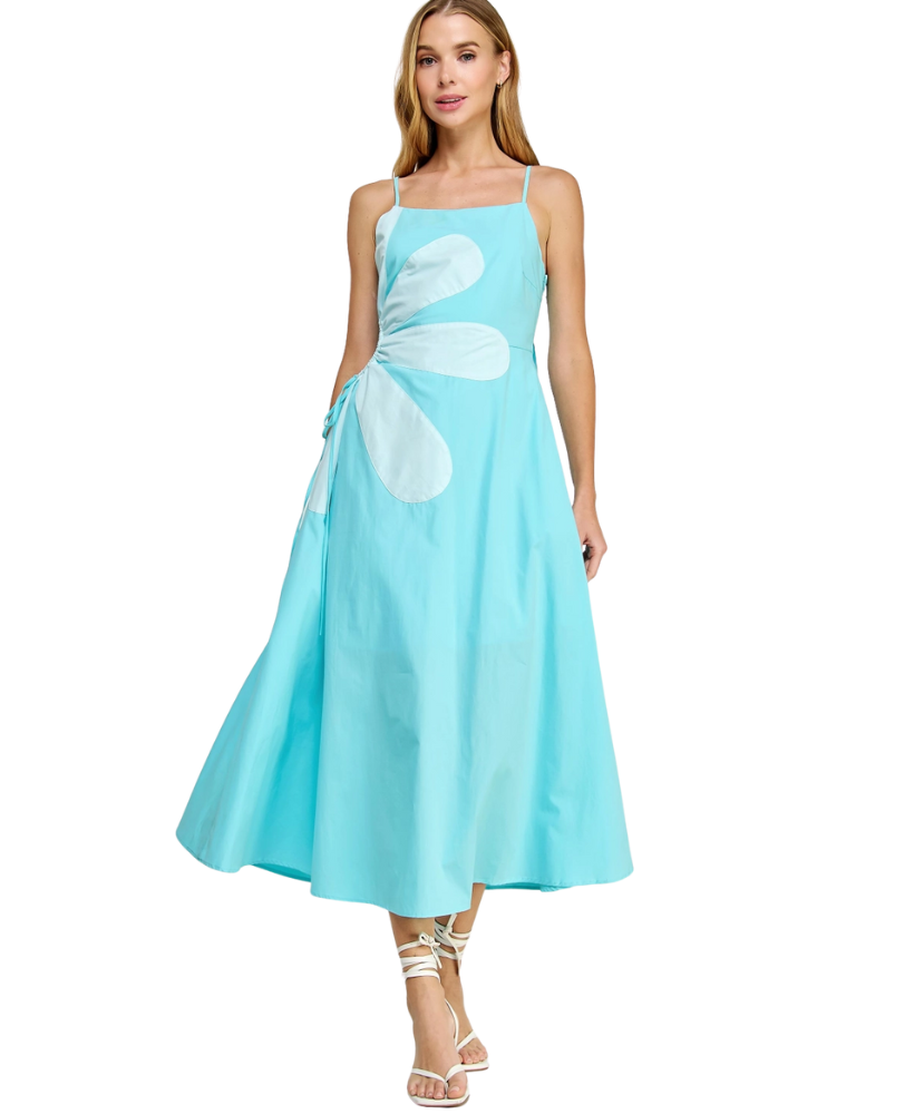 Woman wearing a light blue dress with white floral patterns on a white background