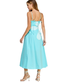 Woman wearing a light blue dress with a white heart design on a white background