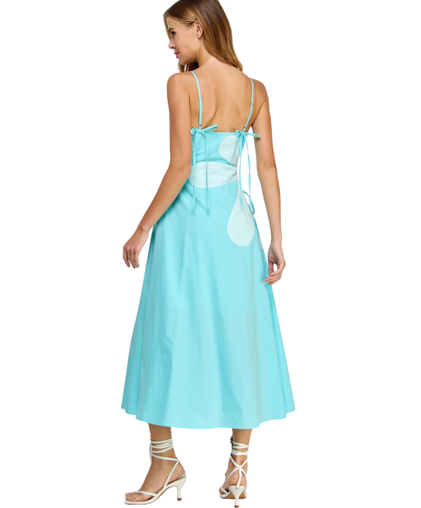 Woman wearing a light blue dress with a white heart design on a white background