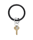 Black leather keychain with a gold key on a white background