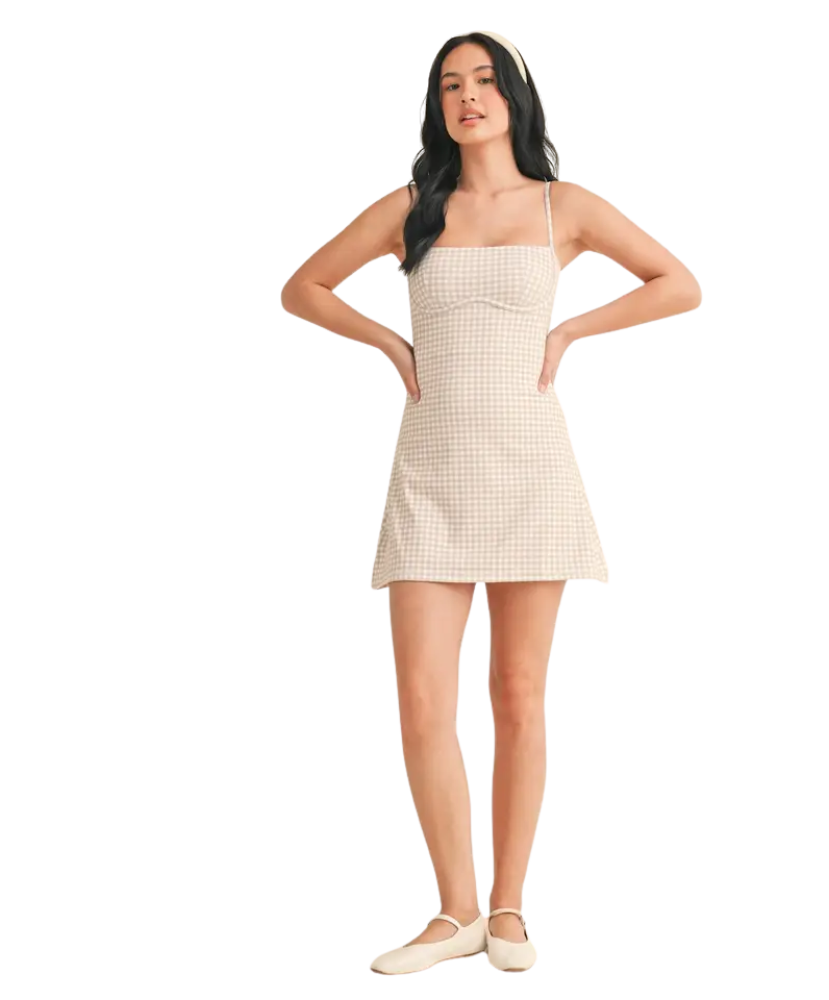 Woman wearing a beige checkered dress on a white background