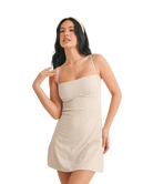 Woman wearing a beige GINGHAM dress on a white background
