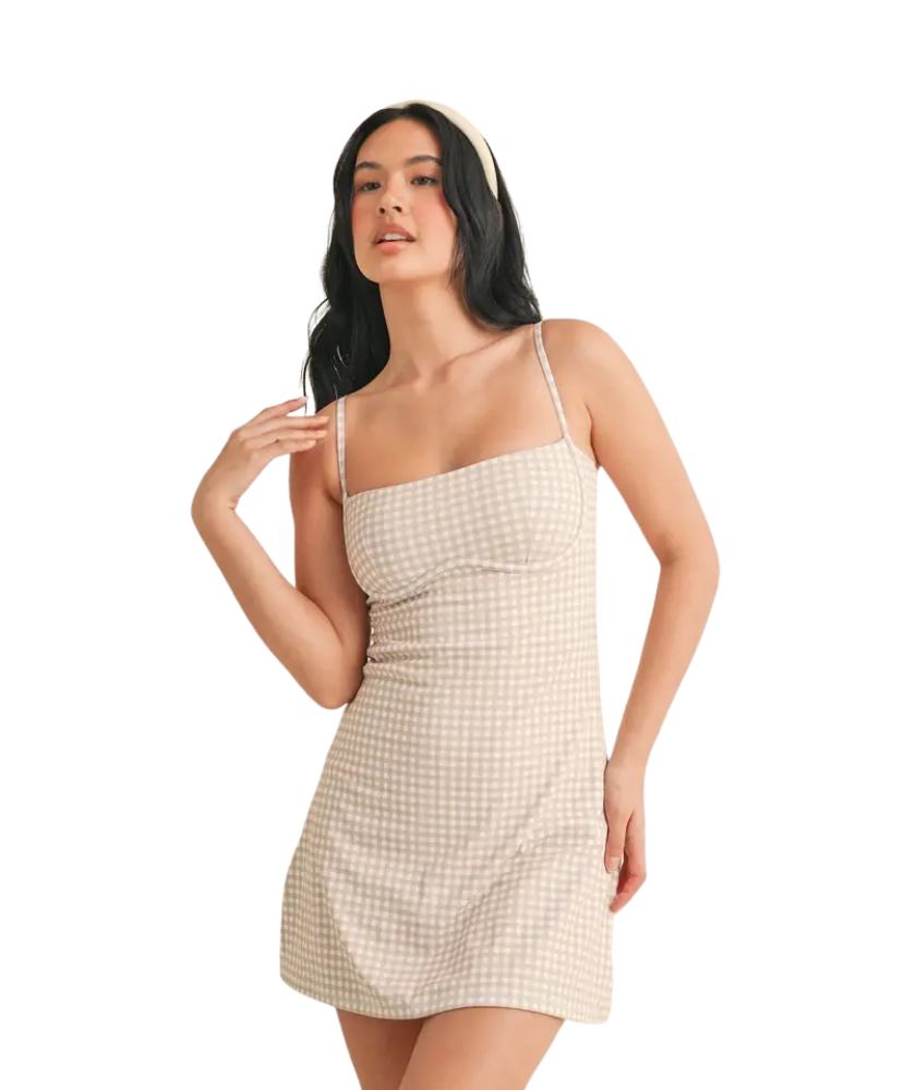 Woman wearing a beige GINGHAM dress on a white background