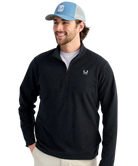 Man wearing a black quarter-zip pullover with a HUK ogo on a white background