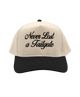 Beige and black cap with 'Never Last a Tailgate' text on a white background