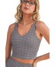 Woman wearing a black and white GINGHAM checkered tank on a white background
