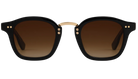 Black Krewe sunglasses with gold accents on a white background