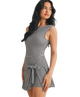 Woman wearing a black and white gingham checkered dress on a white background