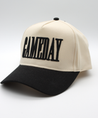 Beige and black cap with 'GAMEDAY' text on a light gray background