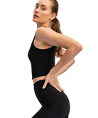 Woman wearing a black athletic outfit on a white background