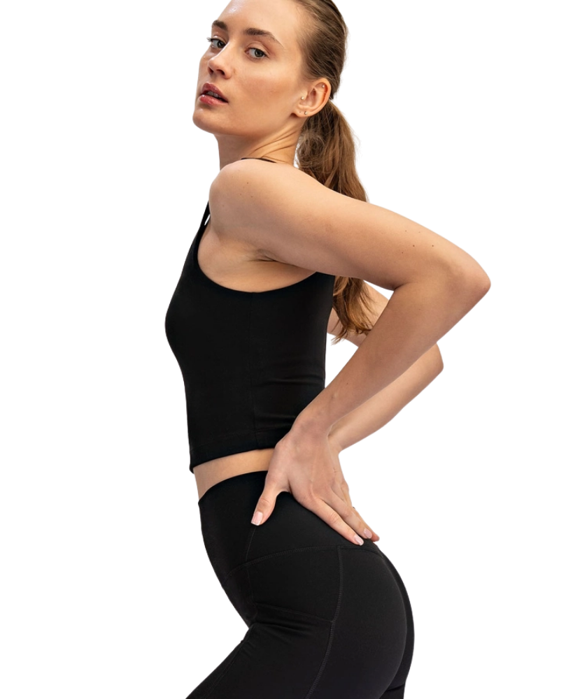 Woman wearing a black athletic outfit on a white background