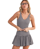Woman wearing a black and white GINGHAM checkered tank on a white background