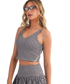 Woman wearing a black and white GINGHAM checkered tank on a white background