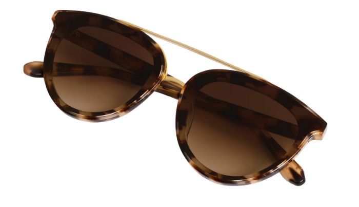 A pair of classic cat-eye sunglasses with a translucent tortoiseshell frame and brown gradient lenses, shown on a plain white background.