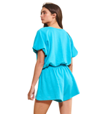 Woman wearing a turquoise dress on a white background