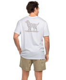 Man wearing a white t-shirt with a CAMO dog graphic on the back, standing against a white background