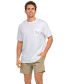 Man wearing a white t-shirt with a CAMO dog graphic on the back, standing against a white background
