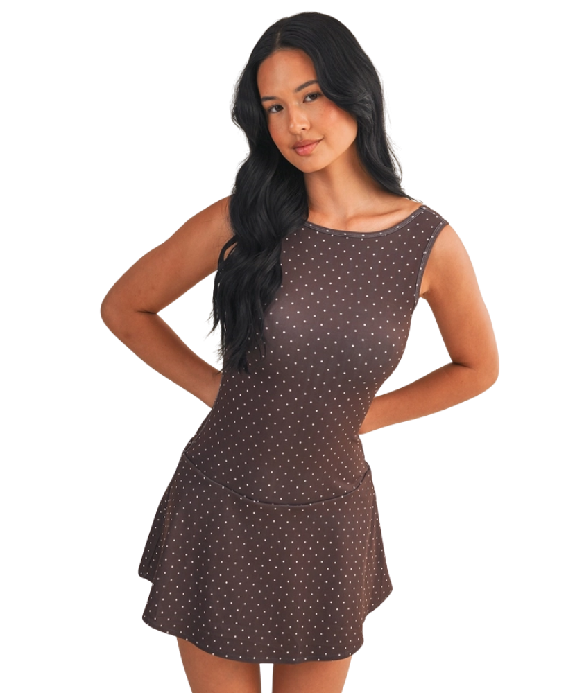 Woman wearing a brown polka dot dress on a white background