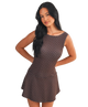 Woman wearing a brown polka dot dress on a white background