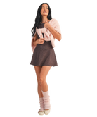 Woman wearing a brown polka dot dress on a white background