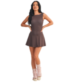 Woman wearing a brown polka dot dress on a white background