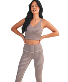 Woman wearing a brown and white GINGHAM checkered tank on a white background