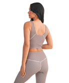 Woman wearing a brown and white GINGHAM checkered tank on a white background