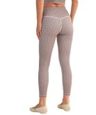 Person wearing gingham checkered outfit on a white background