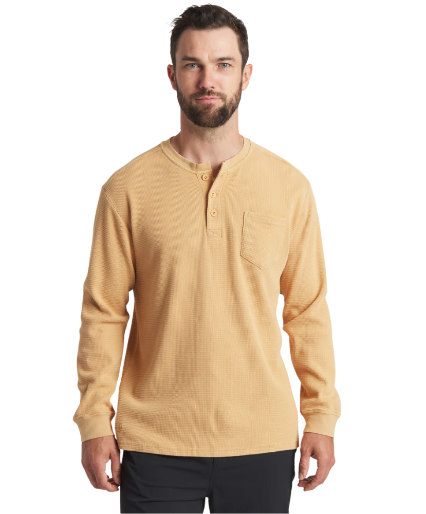 Man wearing a beige long-sleeve henley shirt on a white background