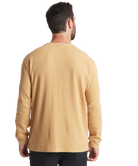 Man wearing a beige long-sleeve henley shirt on a white background