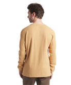 Man wearing a mustard yellow long-sleeve henley shirt on a white background
