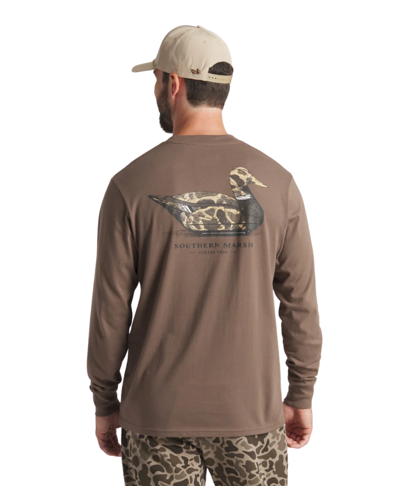 Man wearing a brown long-sleeve shirt with a duck logo on the back, standing against a white background.