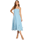 Woman wearing a light blue dress on a white background