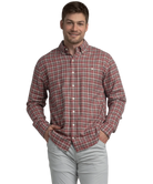 Man wearing a red and brown plaid shirt on a white background