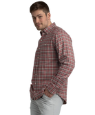 Man wearing a red and gray plaid shirt on a white background